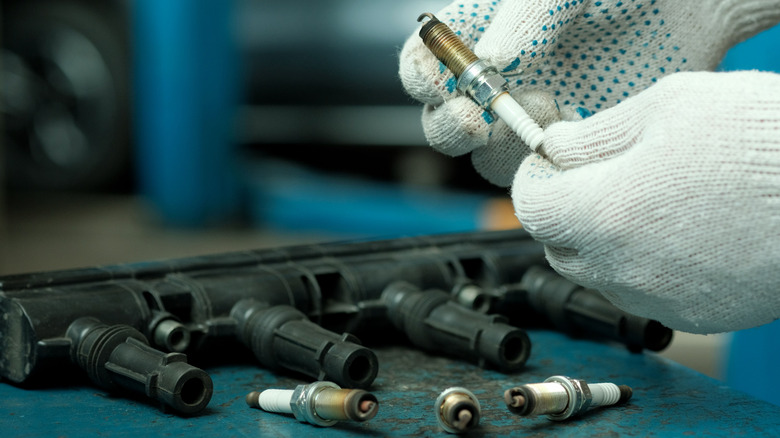 A mechanic checking spark plug and ignition coil condition