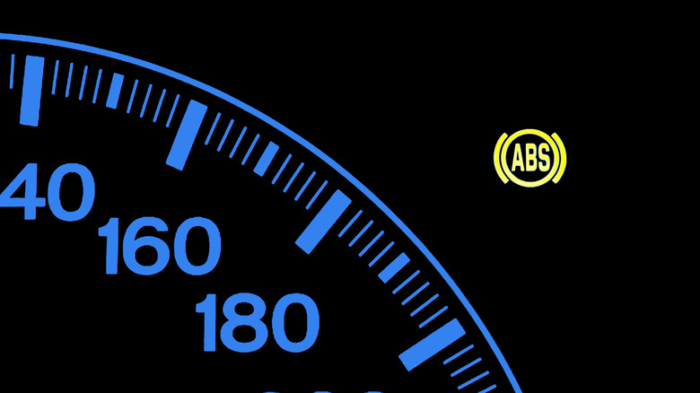 An illuminated ABS warning light on the instrument console of a modern car