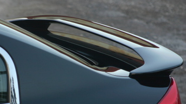 A decklid spoiler atop the tailgate of a sedan.