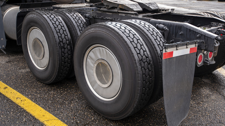 A big rig freight transportation semi truck with tandem axles.