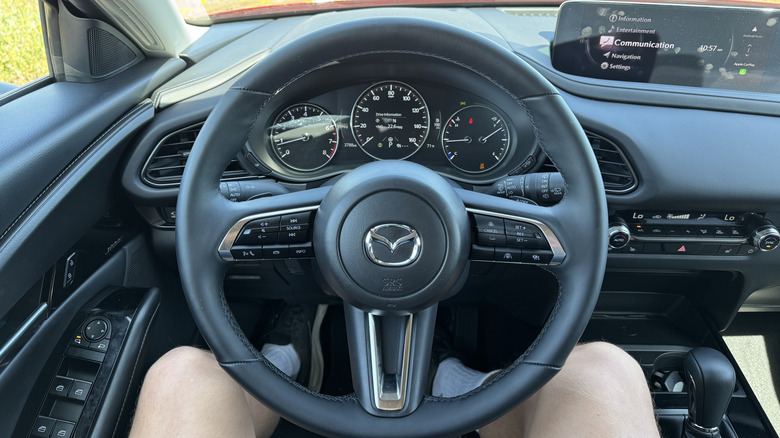 A photo from my POV in the driver's seat of the CX-30 with grass visible out the windows