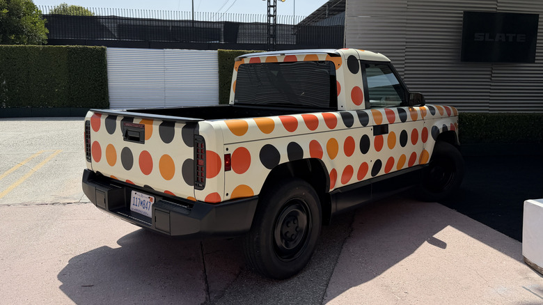 Rear 3/4 view of a Slate truck with a dot wrap