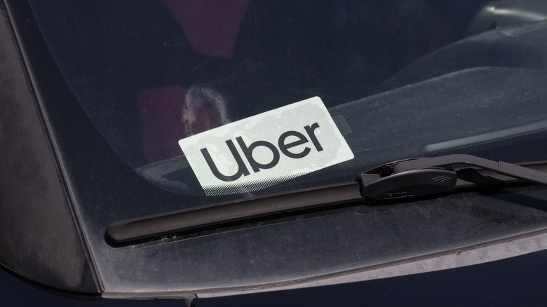 Close-up of an Uber sticker on a windshield.