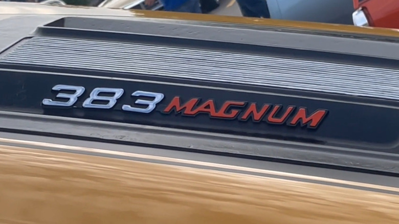 A closeup of the 383 Magnum badge of a gold 1971 Dodge Charger