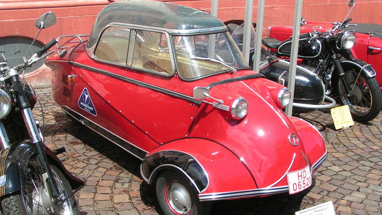 A bright red Messerschmitt KR200 Kabinenroller with its signature clear Plexiglas bubble canopy.