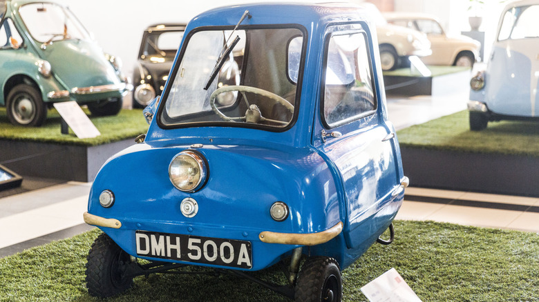 Front 3/4 view of a blue 1962 Peel P50, the smallest microcar ever manufactured, at the microcar exhibition at the Louwman Museum on July 5, 2019 in The Hague,