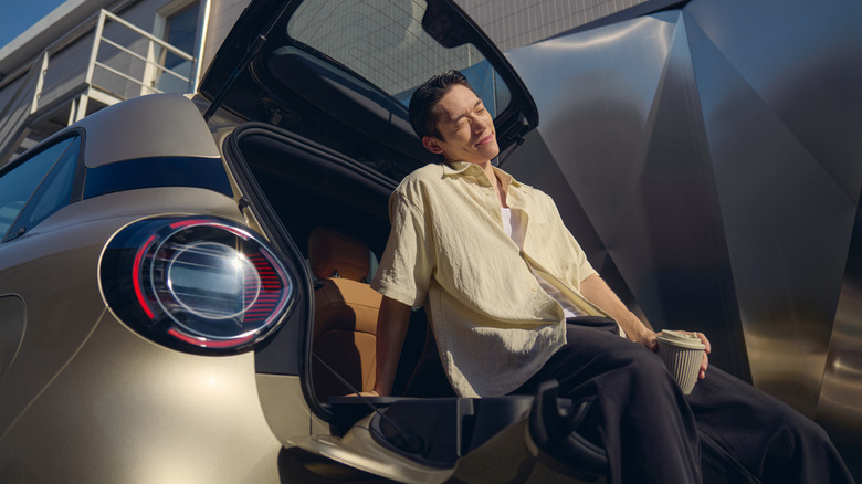Rear of the Smart #2, with someone sitting on the split gate