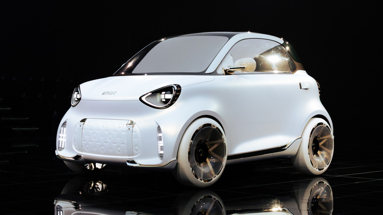 A front three-quarters shot of the white Smart #2 concept shot in a black studio
