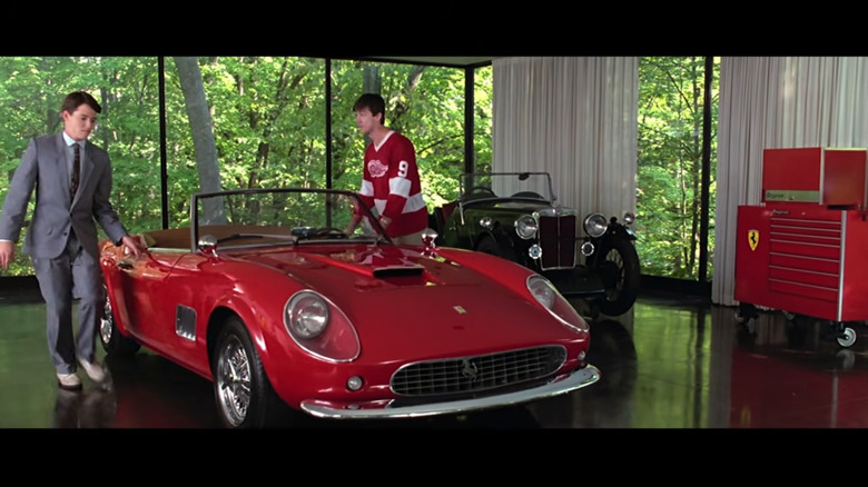 Screenshot from the film of Ferris (Matthew Broderick) with Cameron (Alan Ruck) around the 1961 Ferrari 250 GT California Spyder in Cameron's dad's window-surrounded garage with a red Snap-On toolbox to the side.