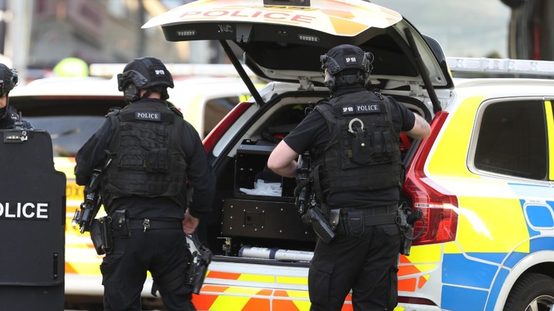 Police grabbing gear from trunk