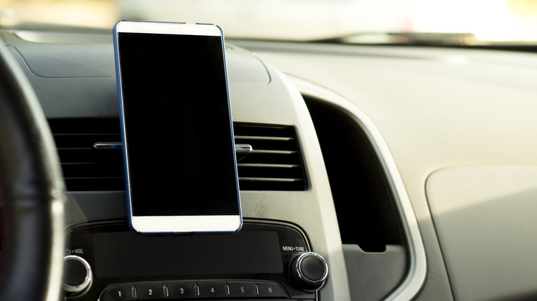 A phone mounted on the car's dash vent.