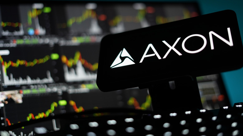 Axon sign on screen with multiple computer screens in the background.