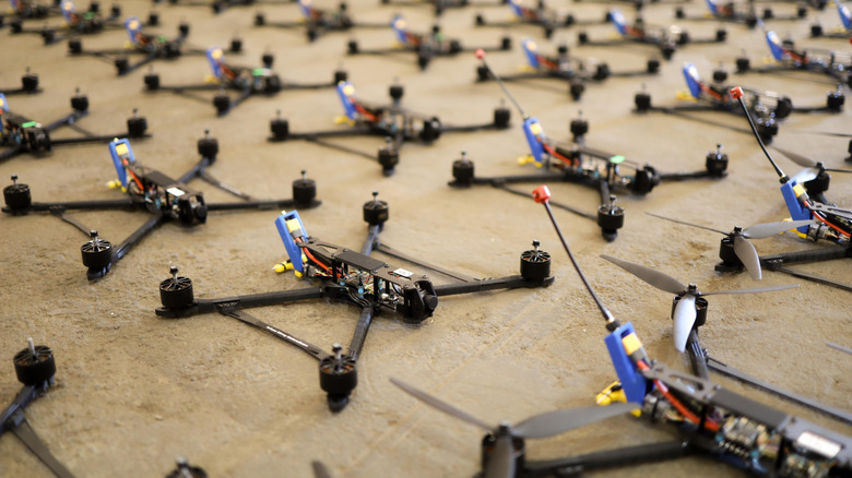 Quadcopter drones laid out on a concrete floor