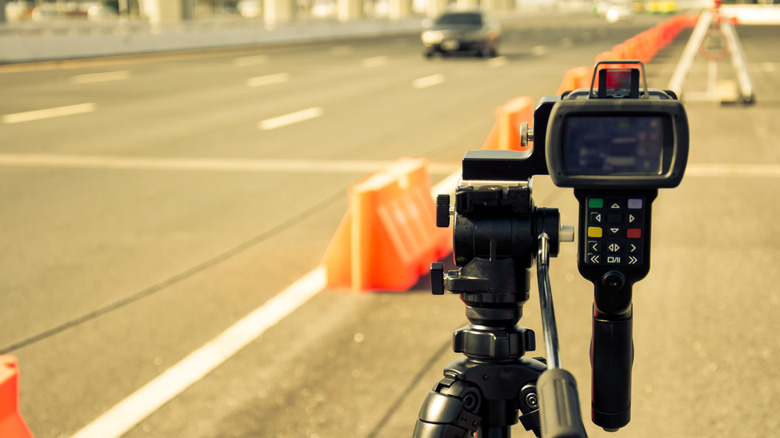 A police speed camera monitoring highway traffic for speeding.