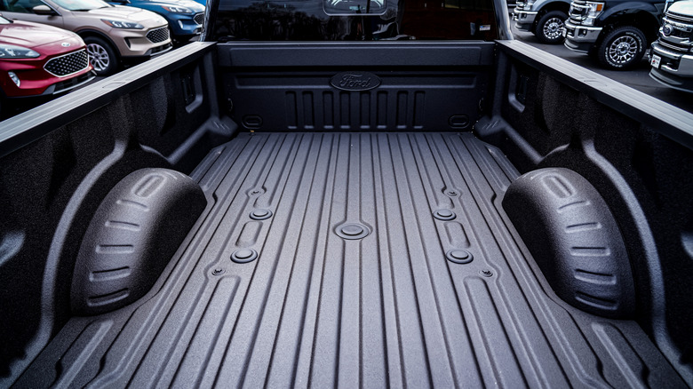 A Ford pick-up truck with a bed liner installed.