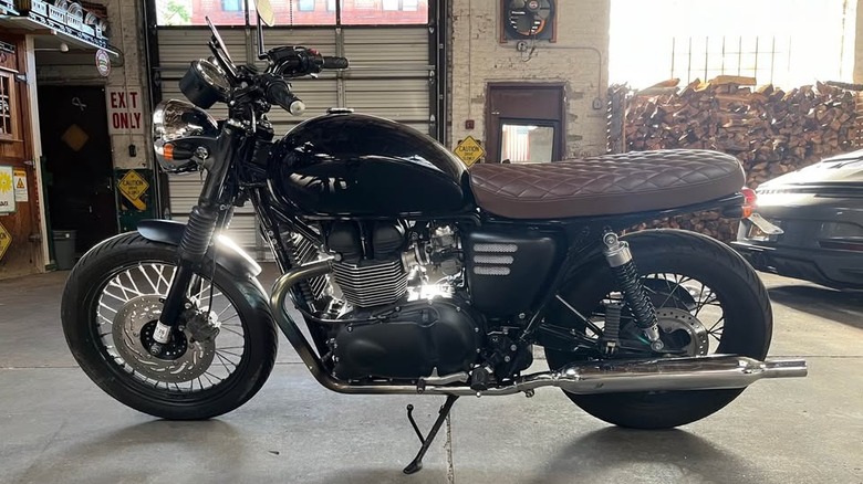 A black Triumph Bonneville with brown seat
