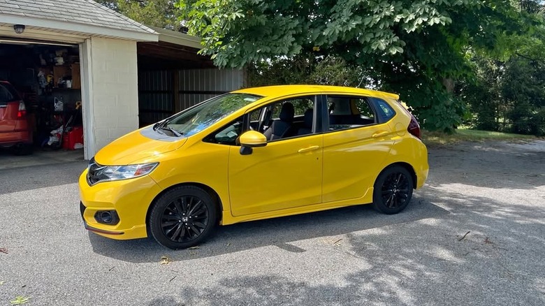 A yellow Honda Fit