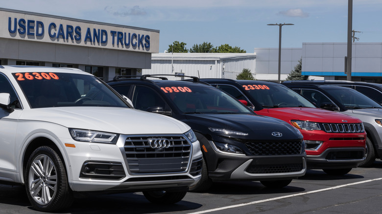 Cars lined up outside of a used car dealership