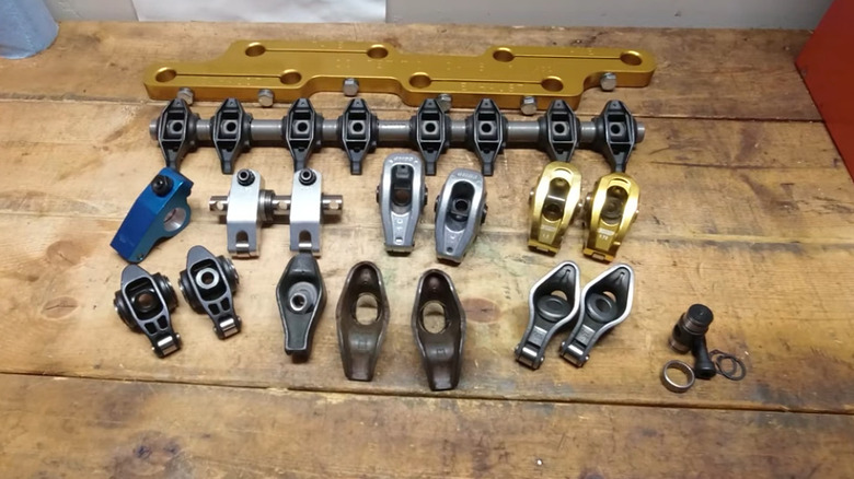 A variety of different rocker arms on a work bench