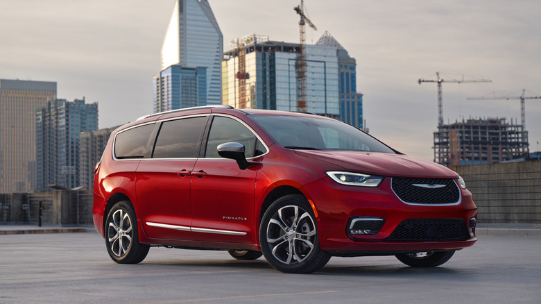 A red Chrysler Pacifica in a parking lot.