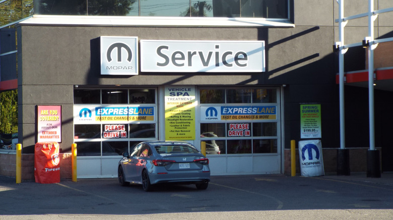 Ottawa, Ontario, Canada-July 19, 2025: A "Mopar Express Lane service center" at a dealership features garage bays and vehicle spa advertisements at 1255 Johnston Rd.