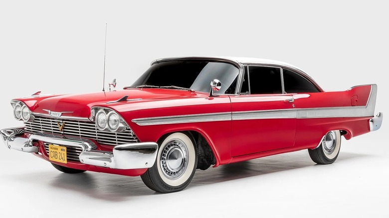 A front three-quarter profile view of a red 1958 Plymouth Fury from the film 