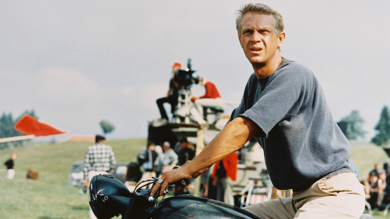 Steve McQueen seen riding a motorcycle during the making of a movie