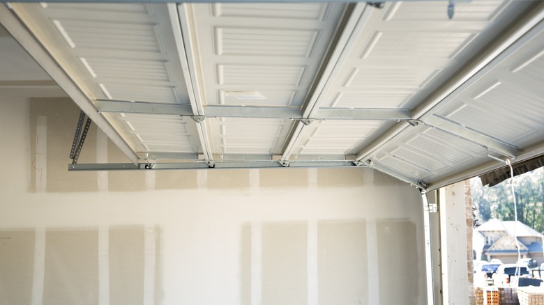 Garage door rollers riding in a clean track.