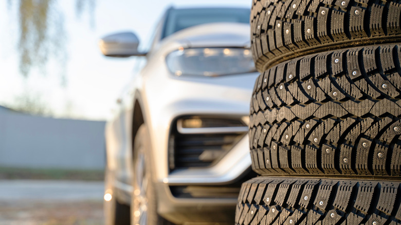 A view of stacked studded tires in front of a vehicle