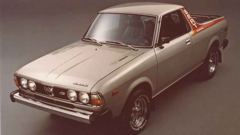 Tan Subaru BRAT pickup front left view in a studioSubaru claimed that BRAT stood for "Bi-Drive Recreational All-Terrain Transporter." Really? C'mon. One might almost suspect Subaru just wanted to call the thing a BRAT, and came up with the acronym to justify it. Whatever; the little BRAT pickup was one of the coolest vehicles Subaru ever made, or at least we think so. From the moment it launched in 1978, it exemplified Subaru's creative approach to car design and engineering, although it was a pickup truck rather than a car.  Or was it? It was based on a Subaru Leone station wagon with the rear of the passenger cabin converted into a truck bed. Therefore the U.S. government was prepared to declare it a truck, which meant it would have been subject to the protectionist "chicken tax," a 25 percent import tariff on light pickups. To avoid the tax, Subaru mounted a pair of rear-facing jump seats in the bed. Believe it or not, this was enough to get it reclassified as a passenger car, subject to only a 2.5 percent import tax.  In 1978, the BRAT featured a 1.6-liter, 67-hp boxer four-cylinder engine, later upgraded to a 1.8-liter, 73-hp version. A short-lived turbo model offered 95 hp and 123 pound-feet of torque–pretty respectable in this tiny trucklet. Its part-time all-wheel drive system gave it some decent dirt-road capabilities. The BRAT only lasted until 1987 in the U.S., despite its general bodaciousness. We definitely consider it an off-roader that deserves a modern revival.