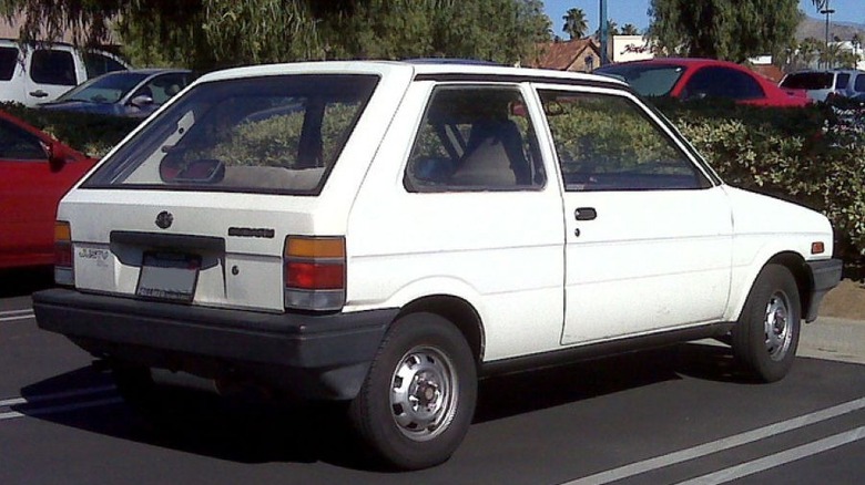 White first-generation US-spec Subaru Justy hatchback right rear view parked