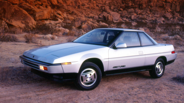 Silver 1985 Subaru XT Turbo left front view parked against a desert backdrop