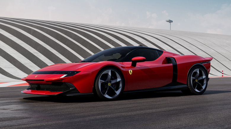 A red Ferrari 849 Testarossa on a track, showcasing its wide, low-slung stance.