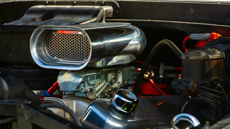 Roots type supercharger on high performance engine with chrome air scoop