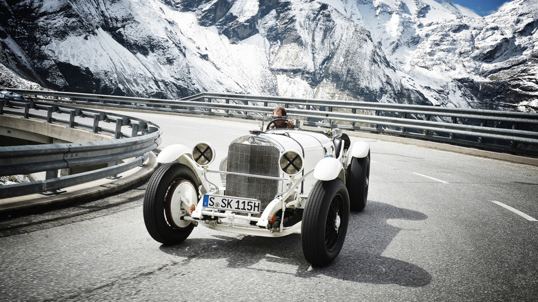 Front 3/4 view of a white 1928 Mercedes-Benz type SSK cornering at speed at the Grossglockner Grand Prix 2012.