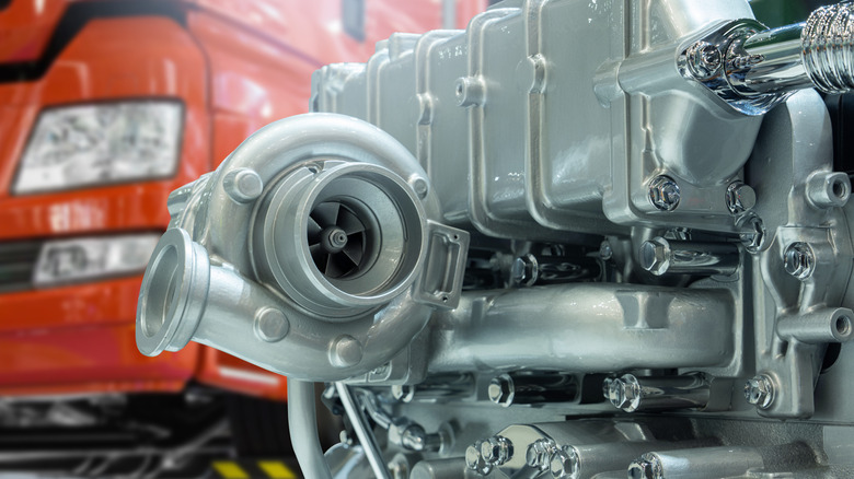 Close-up of diesel engine turbocharger on the background of truck repair service.