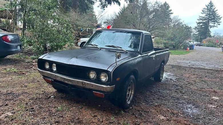 A black Datsun 620 pickup
