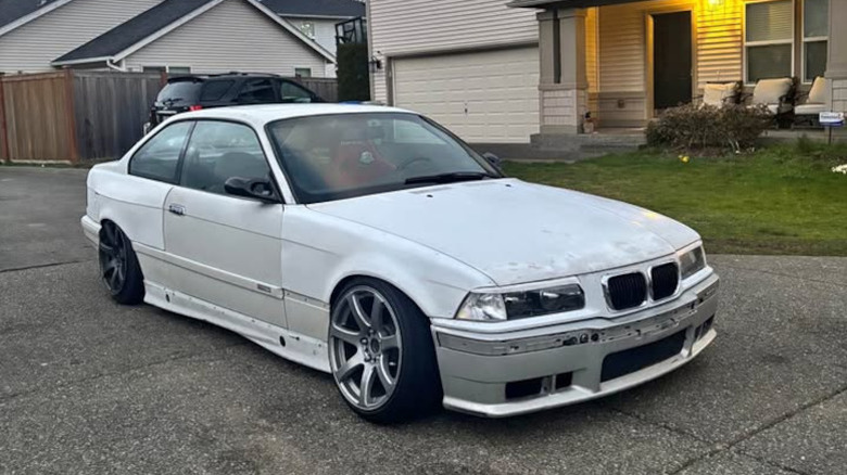 A multicolored but mostly near-white BMW 3-series