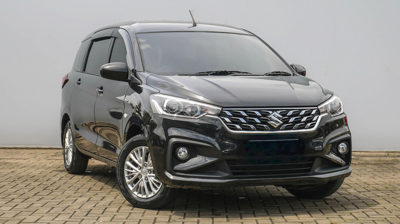 A Suzuki Ertiga MPV on a brick road