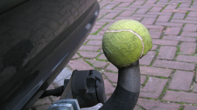 Simple idea to recycle a tennis ball to protect a car hook close up