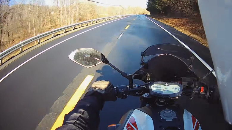 A motorcycle rider's point of view is shown while watching the tachometer during shifting.