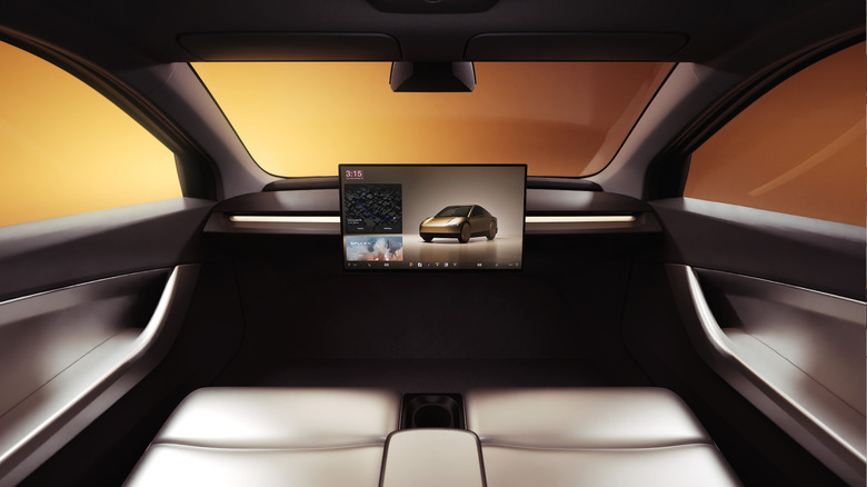 The interior of the Cybercab with attention on the touchscreen on the dashboard, there are no visible human controls inside the car. Like not even door handles.