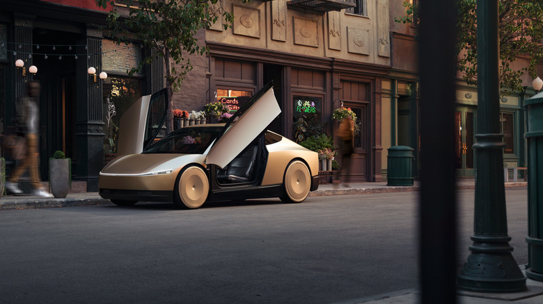A Tesla Cybercab parked in front of a florist, with the Tesla's doors open.