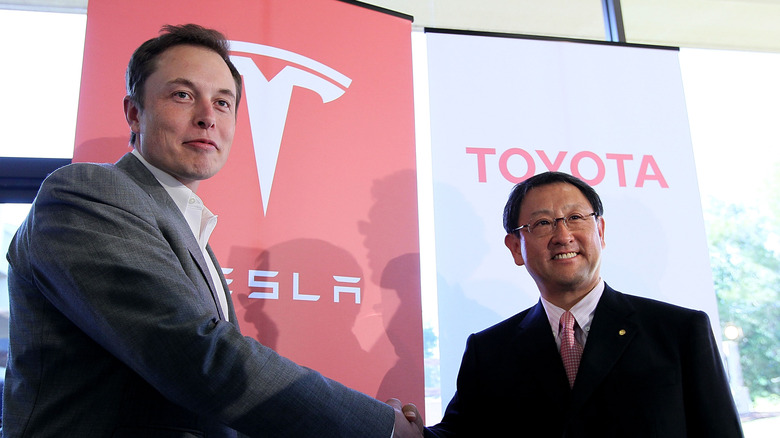 PALO ALTO, CA - MAY 20: Tesla Motors CEO Elon Musk (L) and Toyota CEO Akio Toyoda shake hands after a news conference at Tesla Motors headquarters May 20, 2010 in Palo Alto, California. Electric car maker Tesla Motors annoucned a partnership with Japanese automaker Toyota to make electric cars in the United States. The cars will be manufactured at the recently shuttered NUMMI plant in Fremont, California where Toyota had pulled out after a joint partnership with General Motors had ended. (Photo by Justin Sullivan/Getty Images)