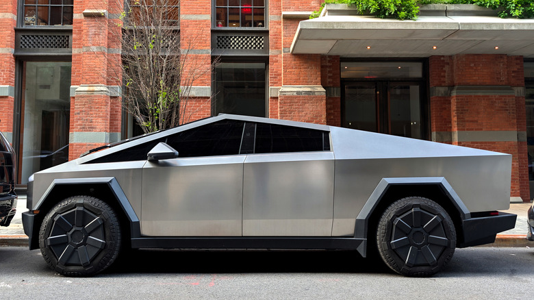 Side profile of a Tesla Cybertruck parked on a NYC street.