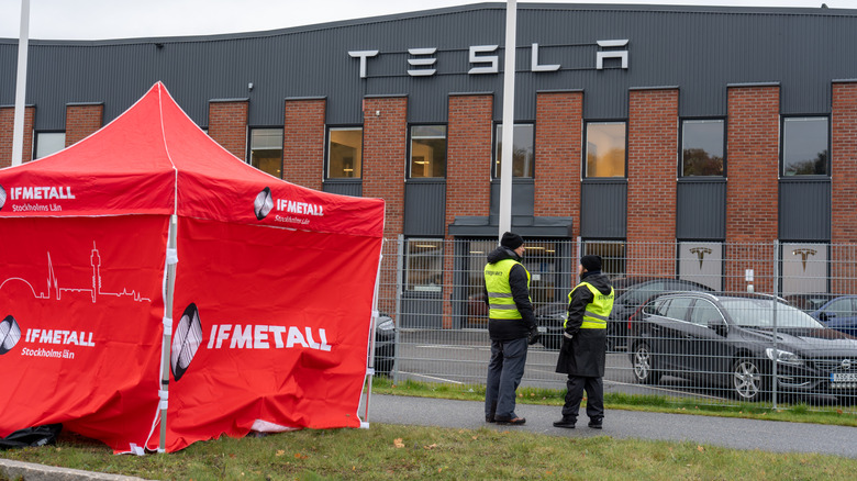 Representatives fron Swedish workers union organisation IF Metall are on site at a Tesla service center in Segeltorp, south of Stockholm, on the first day of a nation-wide strike against the company.