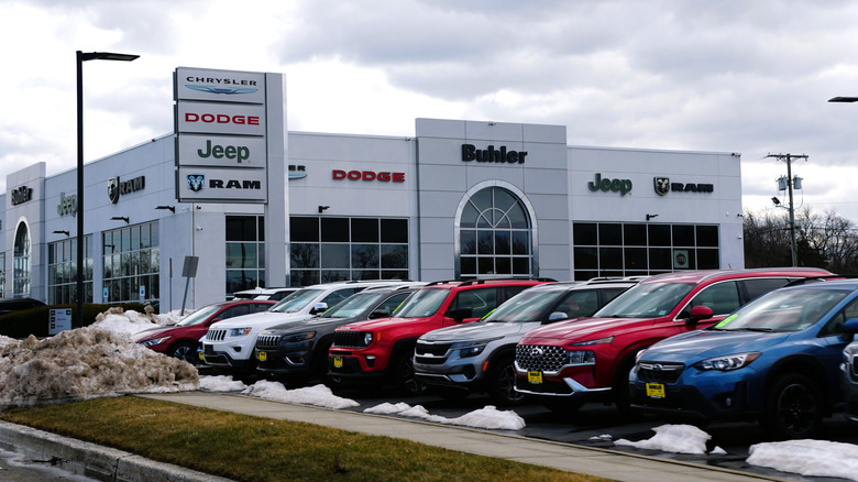 Hazlet, New Jersey, U.S.A - Feb 21, 2026 - Buhler Chrysler Dodge Jeep RAM dealership, displaying multiple vehicle brands with cars parked in front during winter.