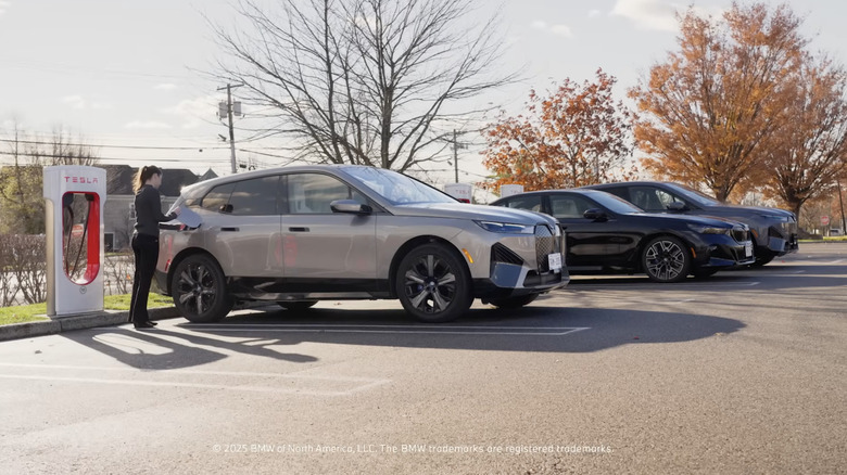 BMW iX at a Tesla Supercharger