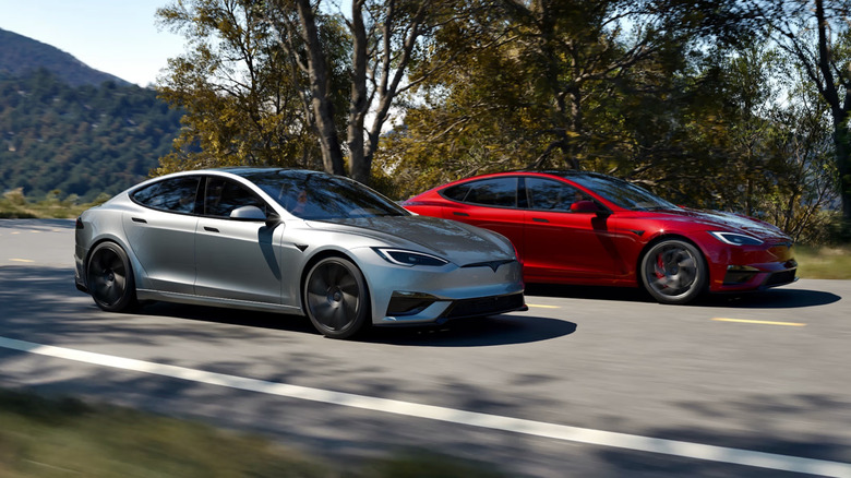 A silver and red Tesla Model S driving next to each other