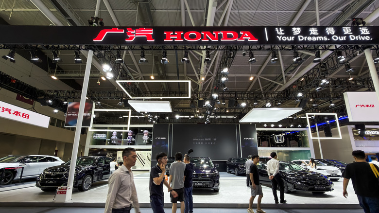 SHENZHEN, CHINA - JUNE 3: Visitors walk past the GAC Honda exhibition booth during the 30th Guangdong-Hong Kong-Macao Greater Bay Area Auto Show on June 3, 2026, in Shenzhen, Guangdong Province, China. GAC Honda, a joint venture between Guangzhou Automobile Group and Honda Motor Co., Ltd., showcases its latest vehicle lineup and automotive technologies as automakers compete for consumer attention in China's automotive market. (Photo by Cheng Xin/Getty Images)